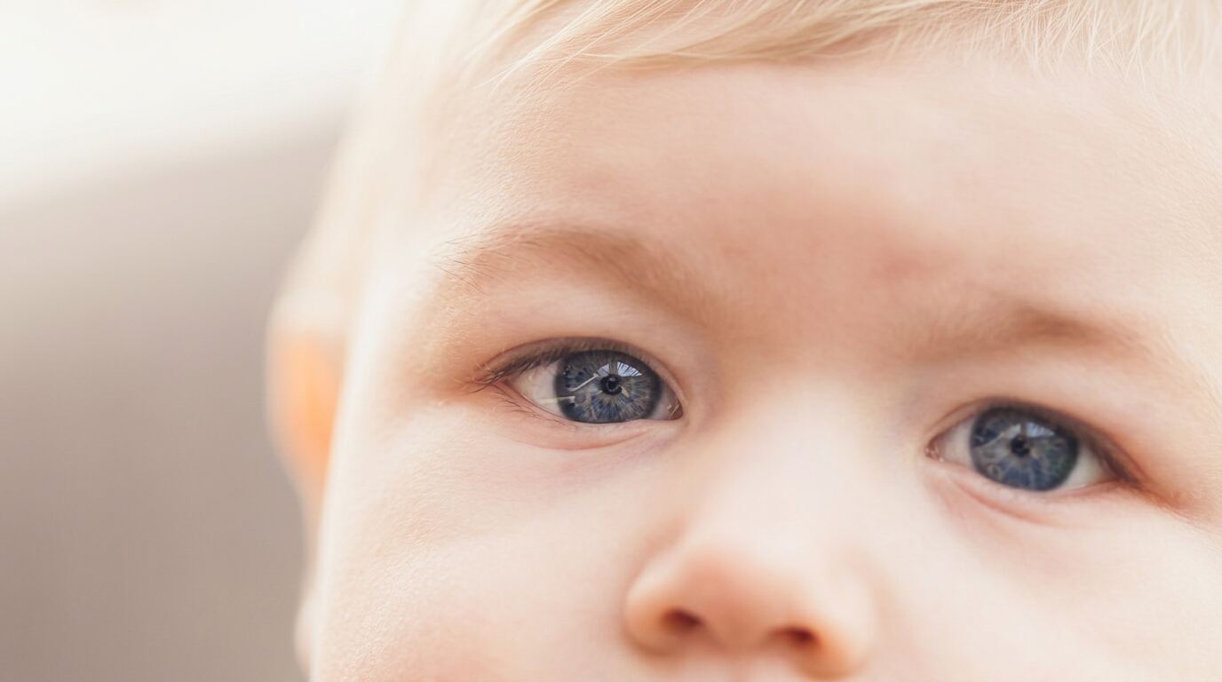 Baby looking at mother during early vision development