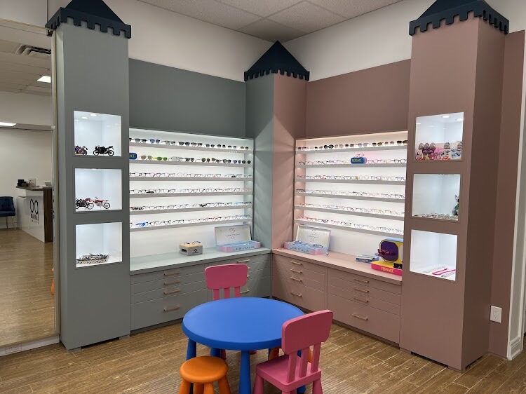 Children's eyewear corner at Parham Optical in Aurora — colourful castle-themed kids' frame displays with little table and chairs for children's eye exams with Dr. Roxanna Gangi.
