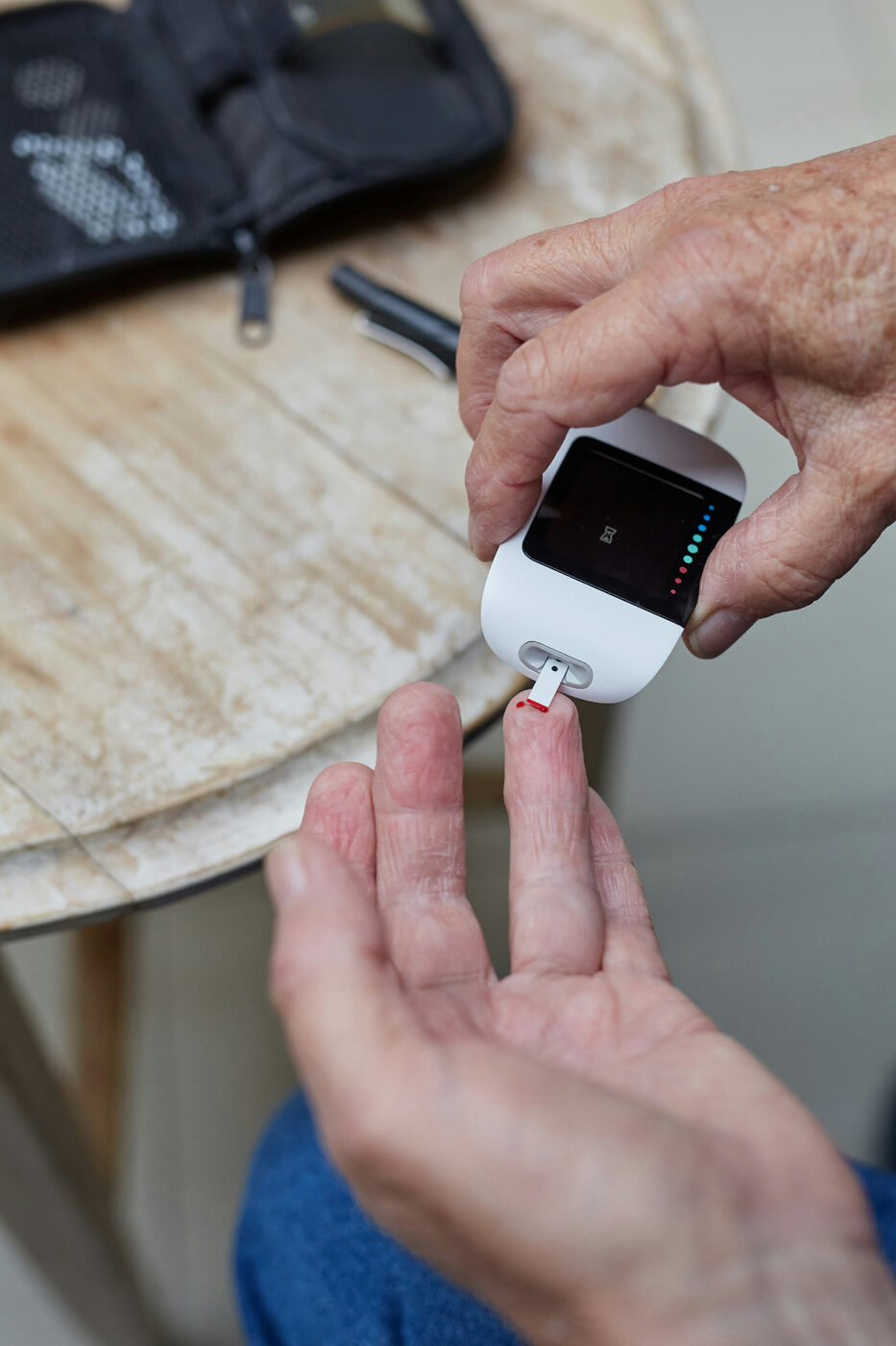 Person checking blood sugar with a glucometer during diabetes management — a key reason to book an annual diabetic eye exam with Dr. Roxanna Gangi, Optometrist in York Region