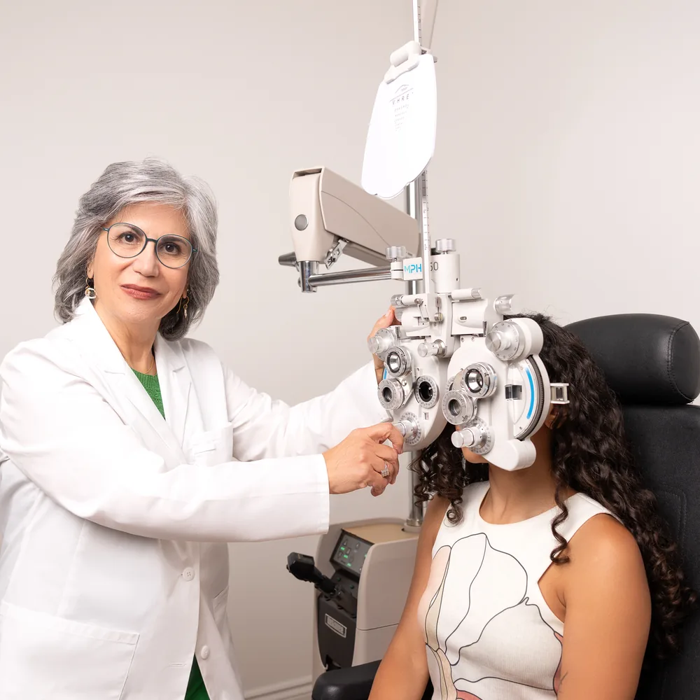 Dr. Roxanna Gangi performing a phoropter refraction on a patient — book an in-person eye exam in York Region