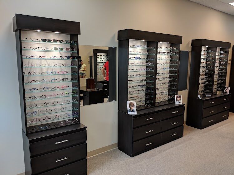 Inside Spencer Optical in Richmond Hill — designer eyeglass frame displays and dispensary cabinets where patients of Dr. Roxanna Gangi choose prescription glasses and sunglasses after their eye exam.